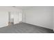 A spacious bedroom with gray carpet and a view into the bathroom at 822 W 24Th St, Sanford, FL 32771