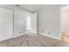 Bright bedroom featuring neutral carpet, closet, and ensuite bathroom access at 916 Kathy St, Daytona Beach, FL 32114