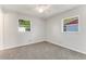 Bedroom with two windows and neutral colored carpet at 916 Kathy St, Daytona Beach, FL 32114