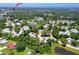 An aerial shot of homes in a well-maintained neighborhood with pond and views of the Tampa skyline at 955 Grayling Ct # B, Port Orange, FL 32127