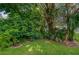 Backyard area with green grass, beautiful landscaping, and mature trees at 955 Grayling Ct # B, Port Orange, FL 32127