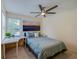 Cozy bedroom featuring a ceiling fan, desk area, and a picturesque window at 955 Grayling Ct # B, Port Orange, FL 32127