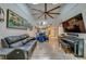 Spacious living room with a modern design, featuring a large sofa, piano, and view into the dining area at 955 Grayling Ct # B, Port Orange, FL 32127