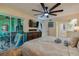 Well-lit main bedroom features a patio door, wooden dresser and ceiling fan at 955 Grayling Ct # B, Port Orange, FL 32127