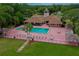 This aerial view highlights the community pool, patio, lounge chairs and gathering spaces at 955 Grayling Ct # B, Port Orange, FL 32127