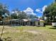 Expansive backyard with a screened-in pool area, offering a private outdoor oasis at 955 Thelma St, Orange City, FL 32763