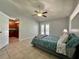 Cozy bedroom with ceiling fan, double doors to backyard, and doorway to the kitchen at 955 Thelma St, Orange City, FL 32763