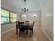Dining area featuring tile flooring, a chandelier, and a window at 955 Thelma St, Orange City, FL 32763