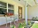 Inviting front porch with a cozy seating area and decorative plants, perfect for relaxing at 955 Thelma St, Orange City, FL 32763