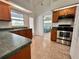 Well-lit kitchen with stainless steel appliances, tile flooring, and a convenient layout at 955 Thelma St, Orange City, FL 32763