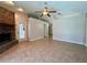 Cozy living room with a brick fireplace, tile flooring, and neutral wall color at 955 Thelma St, Orange City, FL 32763