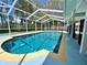 A refreshing pool enclosed by a screened-in patio and lush landscaping at 955 Thelma St, Orange City, FL 32763