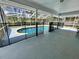 A pool surrounded by a black safety fence inside a screened patio enclosure at 955 Thelma St, Orange City, FL 32763