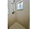 Ensuite shower with glass block window and tiled walls at 955 Thelma St, Orange City, FL 32763