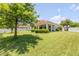 Expansive backyard featuring green lawn and a covered patio extending from the house at 101 Briargate Look, Ormond Beach, FL 32174