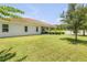 Lush backyard with green lawn and covered patio, creating a serene outdoor space at 101 Briargate Look, Ormond Beach, FL 32174