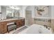 Bathroom featuring a soaking tub, separate vanities, and walk-in shower at 101 Briargate Look, Ormond Beach, FL 32174