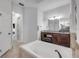 Bathroom with walk-in shower, soaking tub, and dual sink vanity at 101 Briargate Look, Ormond Beach, FL 32174
