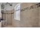 Bathroom featuring an arched walk-in shower with custom mosaic tile accents at 101 Briargate Look, Ormond Beach, FL 32174