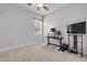 This bedroom has neutral carpet, a ceiling fan, and a desk at 101 Briargate Look, Ormond Beach, FL 32174