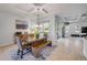 Cozy dining area features a wooden table, bench seating, and view of the outdoor scenery at 101 Briargate Look, Ormond Beach, FL 32174