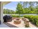 Cozy backyard fire pit with brick accents and manicured lawn at 101 Briargate Look, Ormond Beach, FL 32174