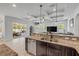 Contemporary kitchen design featuring granite countertops, a stainless steel sink, and seamless access to the living area at 101 Briargate Look, Ormond Beach, FL 32174