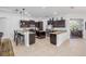 Modern kitchen with dark cabinets, granite countertops, stainless steel appliances, and breakfast bar seating at 101 Briargate Look, Ormond Beach, FL 32174