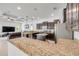 Open kitchen with granite countertops, dark cabinetry, and a view to the living room area at 101 Briargate Look, Ormond Beach, FL 32174