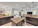 Spacious open kitchen boasts dark cabinets, granite countertops, and a center island for ample workspace at 101 Briargate Look, Ormond Beach, FL 32174