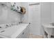 Functional laundry room with washer, dryer, utility sink and storage shelving at 101 Briargate Look, Ormond Beach, FL 32174