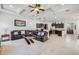 Open-concept living room with a plush rug, leather furniture, a modern glass table, and stylish decor at 101 Briargate Look, Ormond Beach, FL 32174