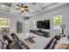 Bright living room featuring coffered ceilings, a ceiling fan, and a comfortable leather sofa with a stylish glass table at 101 Briargate Look, Ormond Beach, FL 32174