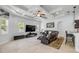 Bright living room with coffered ceiling, tile floors, a ceiling fan, and comfortable leather seating at 101 Briargate Look, Ormond Beach, FL 32174