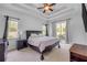 Inviting bedroom with carpet flooring, a king-size bed, soft lighting, and access to a private outdoor area at 101 Briargate Look, Ormond Beach, FL 32174