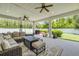Covered patio offers an outdoor living space with furniture, ceiling fans and a grill at 101 Briargate Look, Ormond Beach, FL 32174