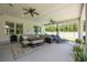 Covered outdoor patio featuring seating, ceiling fans, and views of the backyard at 101 Briargate Look, Ormond Beach, FL 32174