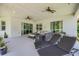 Covered patio featuring lounge furniture, ceiling fans, and sliding glass doors to the home's interior at 101 Briargate Look, Ormond Beach, FL 32174