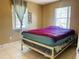 Cozy bedroom with tile flooring, neutral walls, and bright windows providing natural light at 1025 Persian St, Deltona, FL 32725