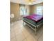 Cozy bedroom with tile flooring, neutral walls, and bright windows providing natural light at 1025 Persian St, Deltona, FL 32725