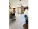 Open-concept living room with tile floors, large windows, and a comfortable seating area at 1025 Persian St, Deltona, FL 32725