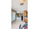 Bright living room with tile floors, ceiling fan, and an open view to the kitchen area at 1025 Persian St, Deltona, FL 32725