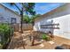 Backyard with mature tree, wooden stumps, gravel covering, and pavers at 1056 Stevens St, Lake Helen, FL 32744