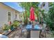 Backyard patio with a table, seating for four, and red umbrella at 1056 Stevens St, Lake Helen, FL 32744