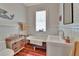 Charming bathroom features a clawfoot tub, a sink, and wood paneled walls, creating a relaxing and inviting space at 1056 Stevens St, Lake Helen, FL 32744
