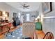 Bright bedroom featuring a ceiling fan, hardwood floors, a decorative bicycle, and comfortable furnishings at 1056 Stevens St, Lake Helen, FL 32744