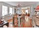 Spacious dining room with a chandelier, large windows, and hardwood floors, ideal for Gathering gatherings and entertaining guests at 1056 Stevens St, Lake Helen, FL 32744