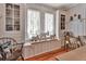 Bright dining area with built-in shelving, hardwood floors, and charming decor, creating a warm and inviting atmosphere at 1056 Stevens St, Lake Helen, FL 32744