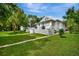 Charming home featuring a manicured lawn and a classic white picket fence, evoking a welcoming and picturesque curb appeal at 1056 Stevens St, Lake Helen, FL 32744