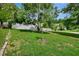 Front yard view of mature tree and greenery overlooking street at 1056 Stevens St, Lake Helen, FL 32744